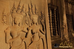 Devatas in Angkor Wat with early morning light