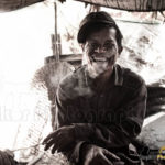 smiling and smoking Cambodian man