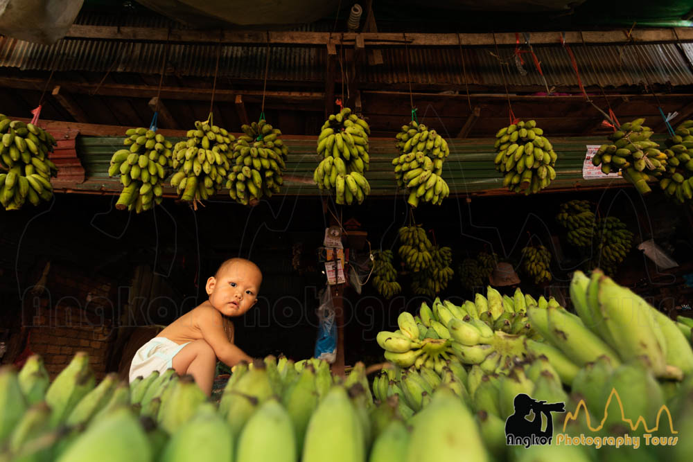 baby in banana market cambodia