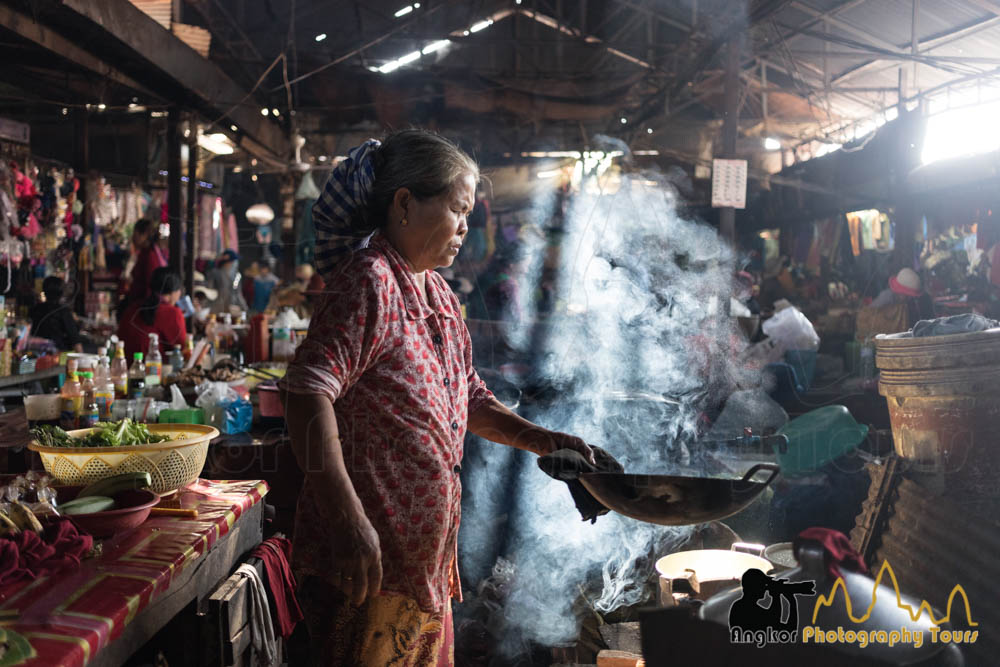 cook in local market cambodia