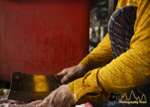 seller cutting chicken yellow red